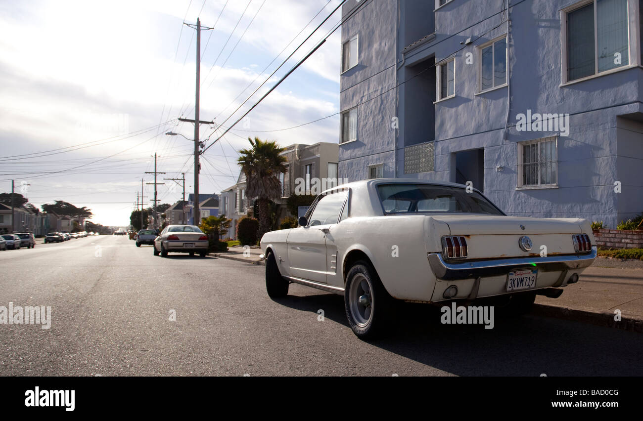 A three quarter rear view of an old Mustang parked on Ortega Street in San Francisco, California, USA. Stock Photo