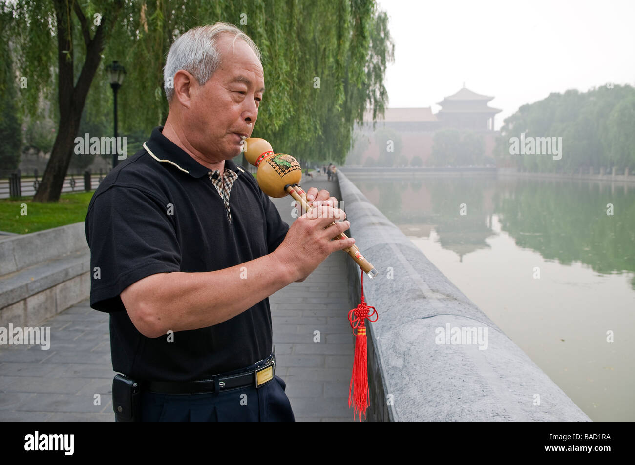 Man plays traditional wooden flute in Zhongshan Park outside Forbidden