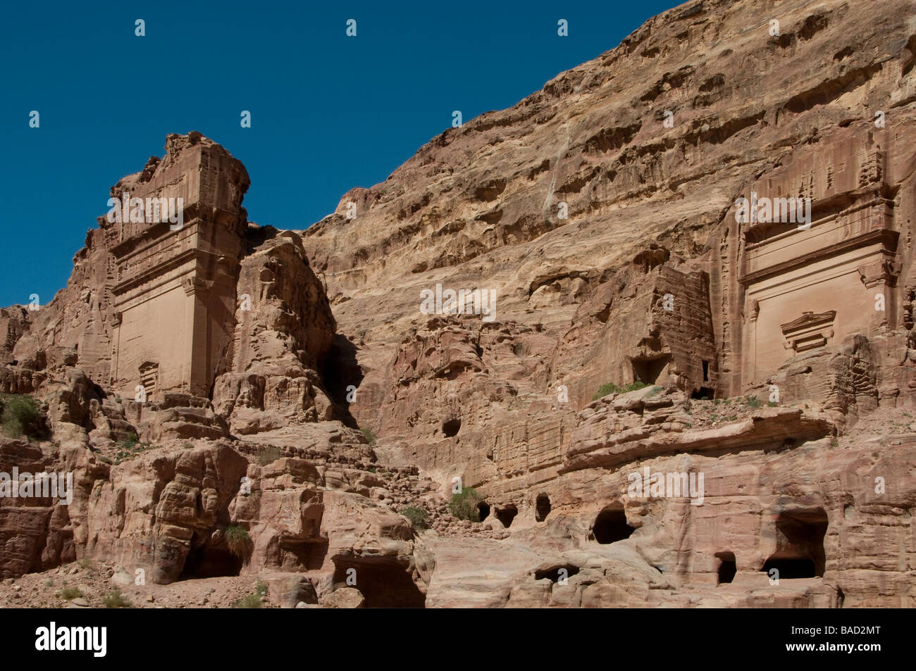 View of the Aneisho and Uneishu rock cut Tombs carved into cliff face in the ancient Nabatean city of Petra Jordan Stock Photo