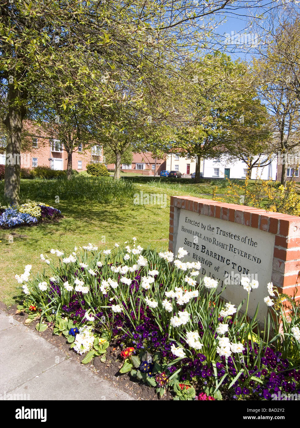 A well kept public garden in Greatham village with a stone