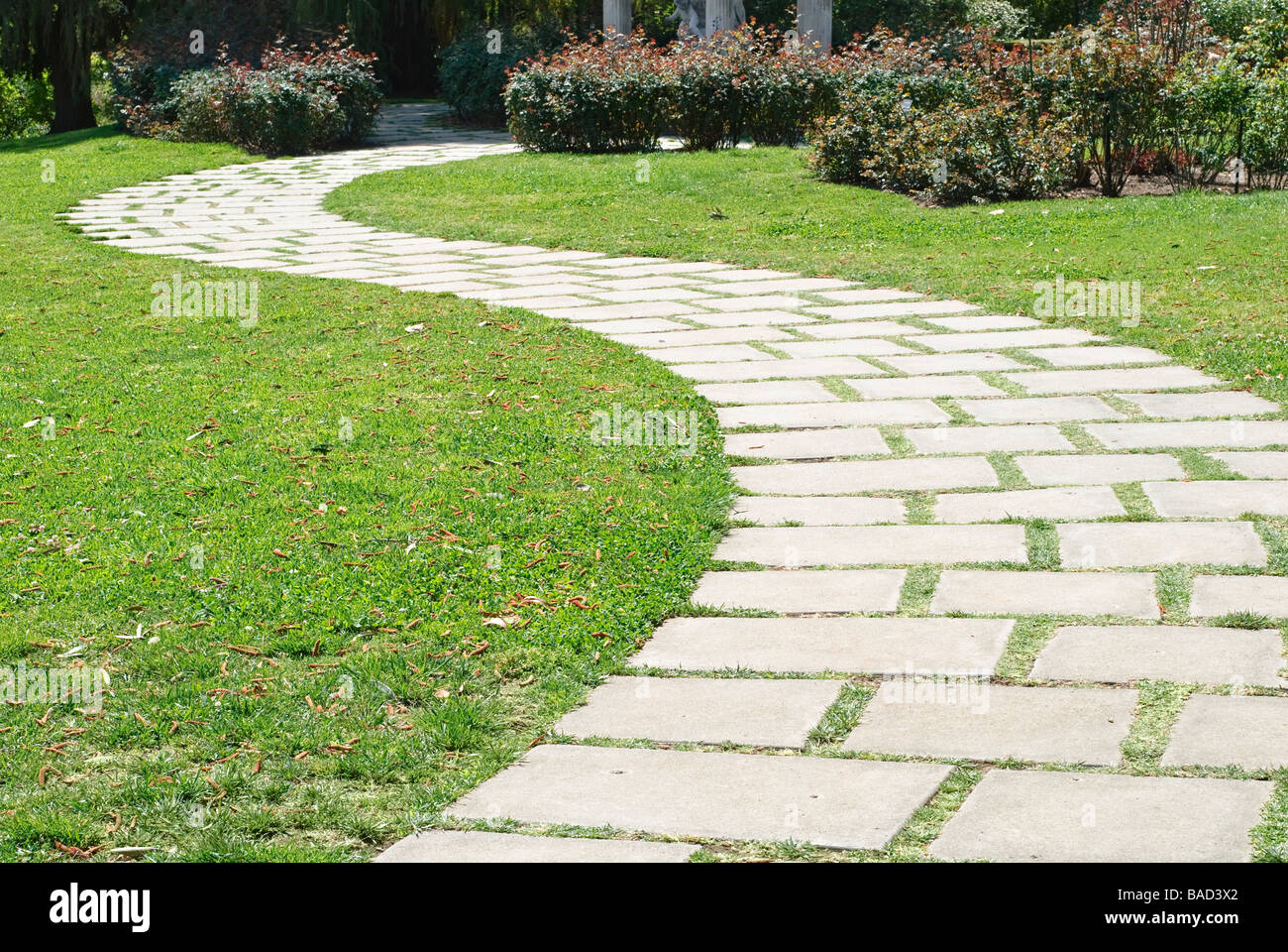 Granite Path in garden with green grass Stock Photo