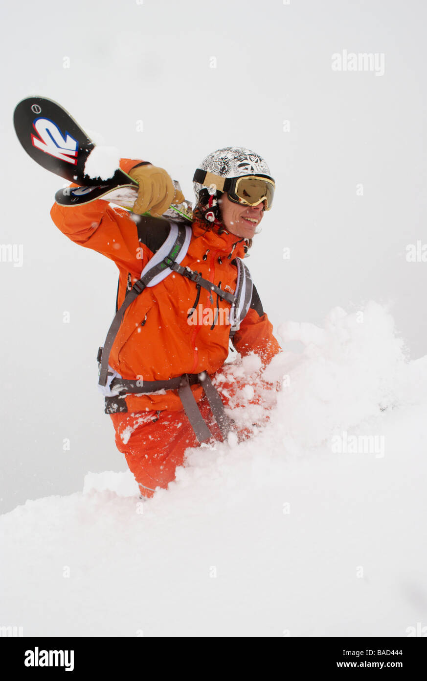 Skier walking up a slope in deep powder snow, Chamonix, France Stock Photo
