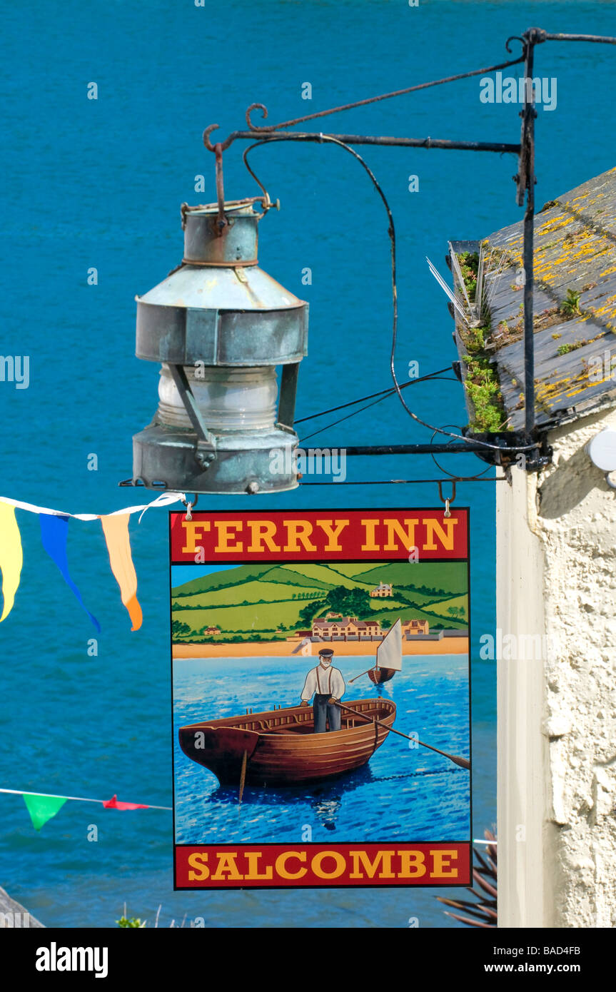 Pub sign outside Ferry Inn pub in an alleyway going down  to the Salcombe passenger ferry with the sea as a background.  Salcombe, Devon, England,UK Stock Photo