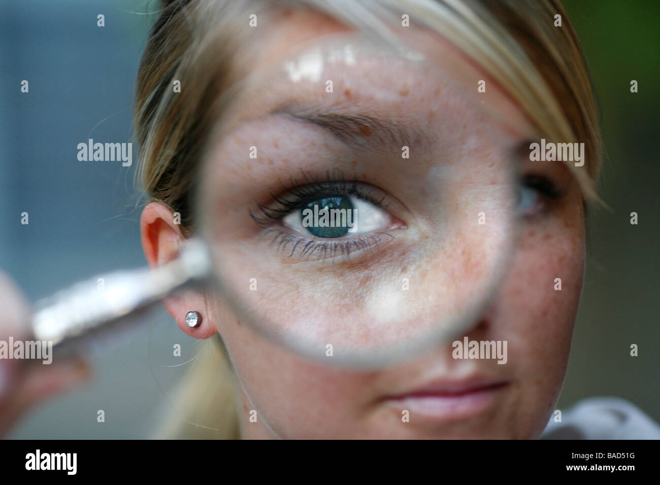Eye through a magnifying glass enlarged Stock Photo Alamy