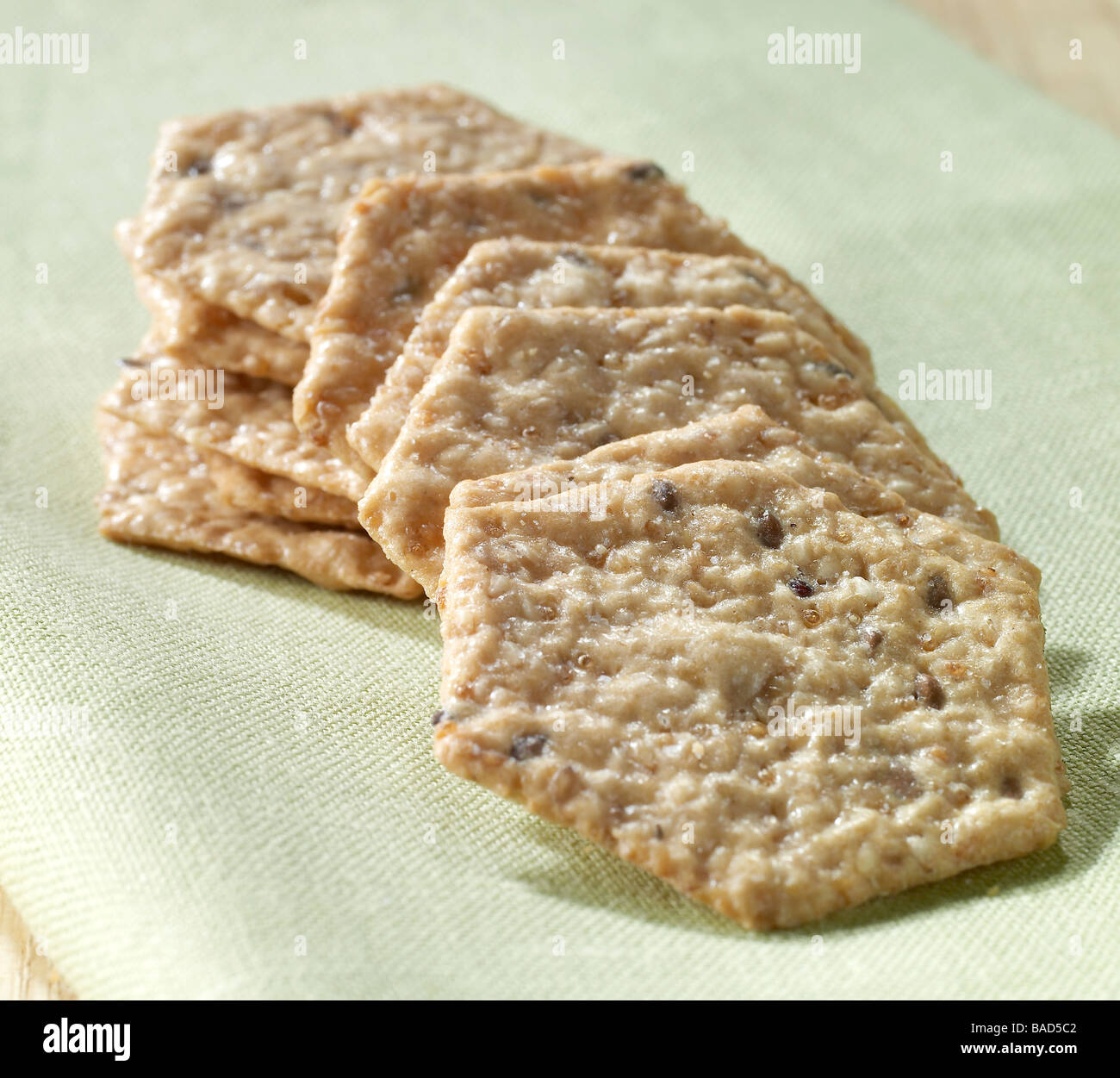 Multi grain crackers on a green background Stock Photo
