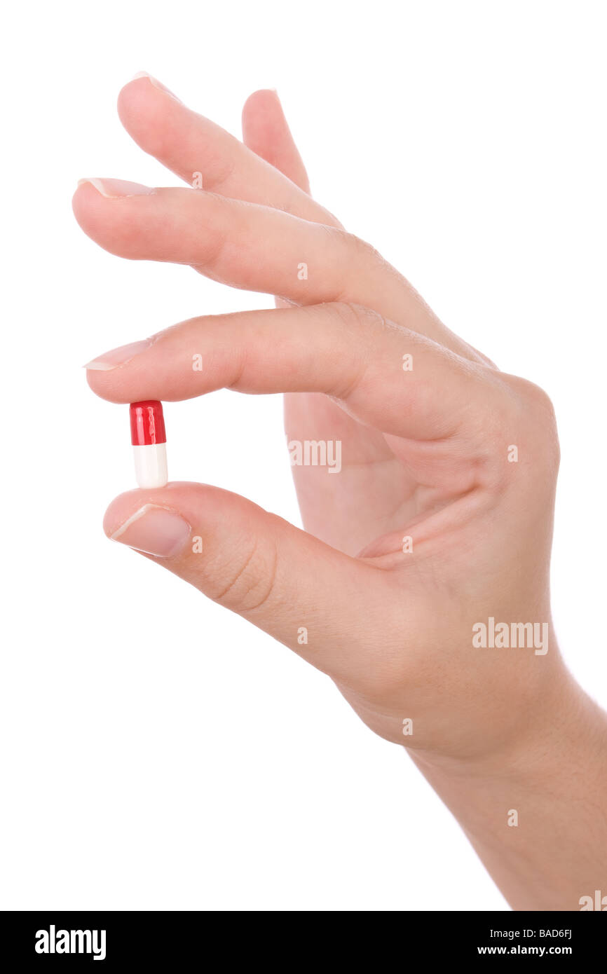 Hand holding a capsule or pill isolated on white Stock Photo