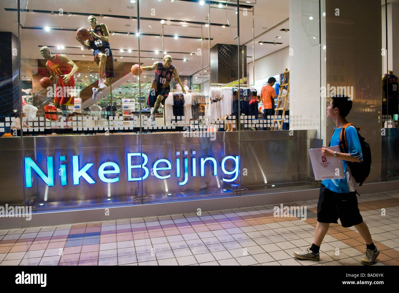 Shopper passes Nike store on pedestrian mall Wangfujing Street, Beijing,  China Stock Photo - Alamy