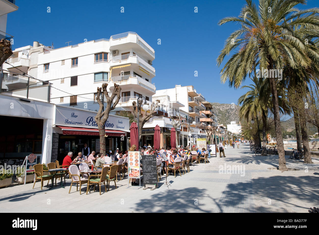 People sitting and eating al fresco outside a restaurant in Puerto Pollensa Mallorca Spain Stock Photo