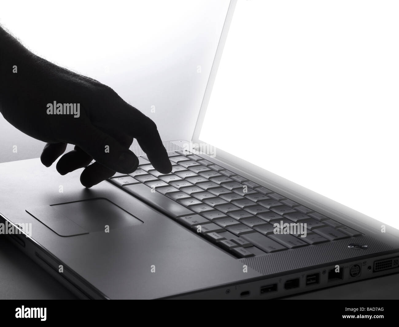 Hand & Laptop Computer Keyboard With Screen Glowing Stock Photo