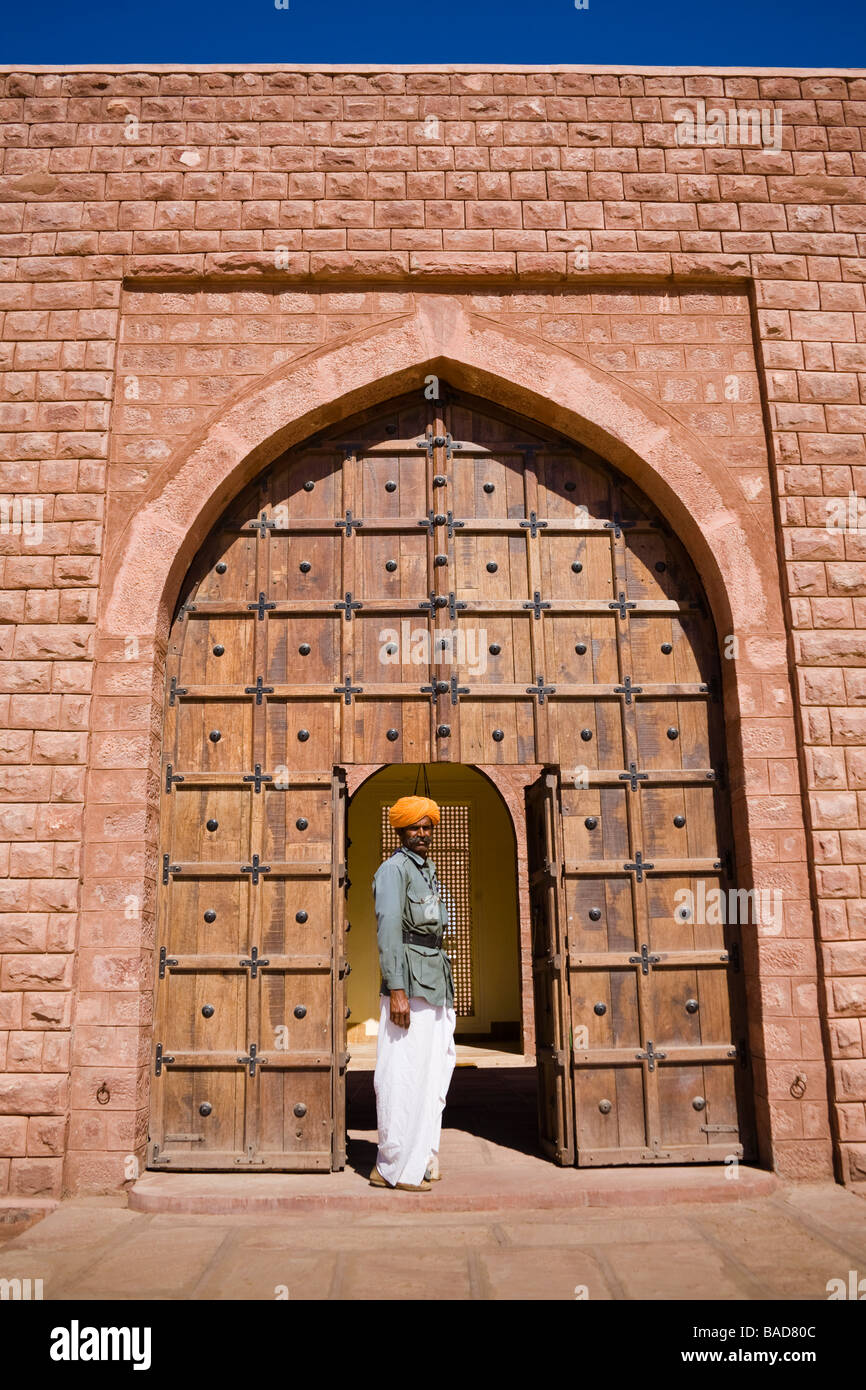 Man standing in a doorway at Osian Camel Camp, Osian, Rajasthan, India Stock Photo