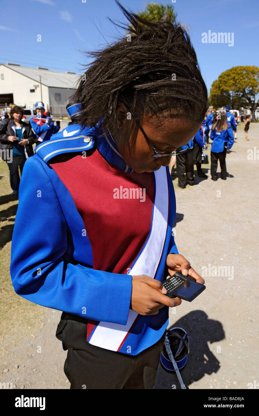 African American high school band member text messaging at Strawberry Festival Plant City Florida Stock Photo