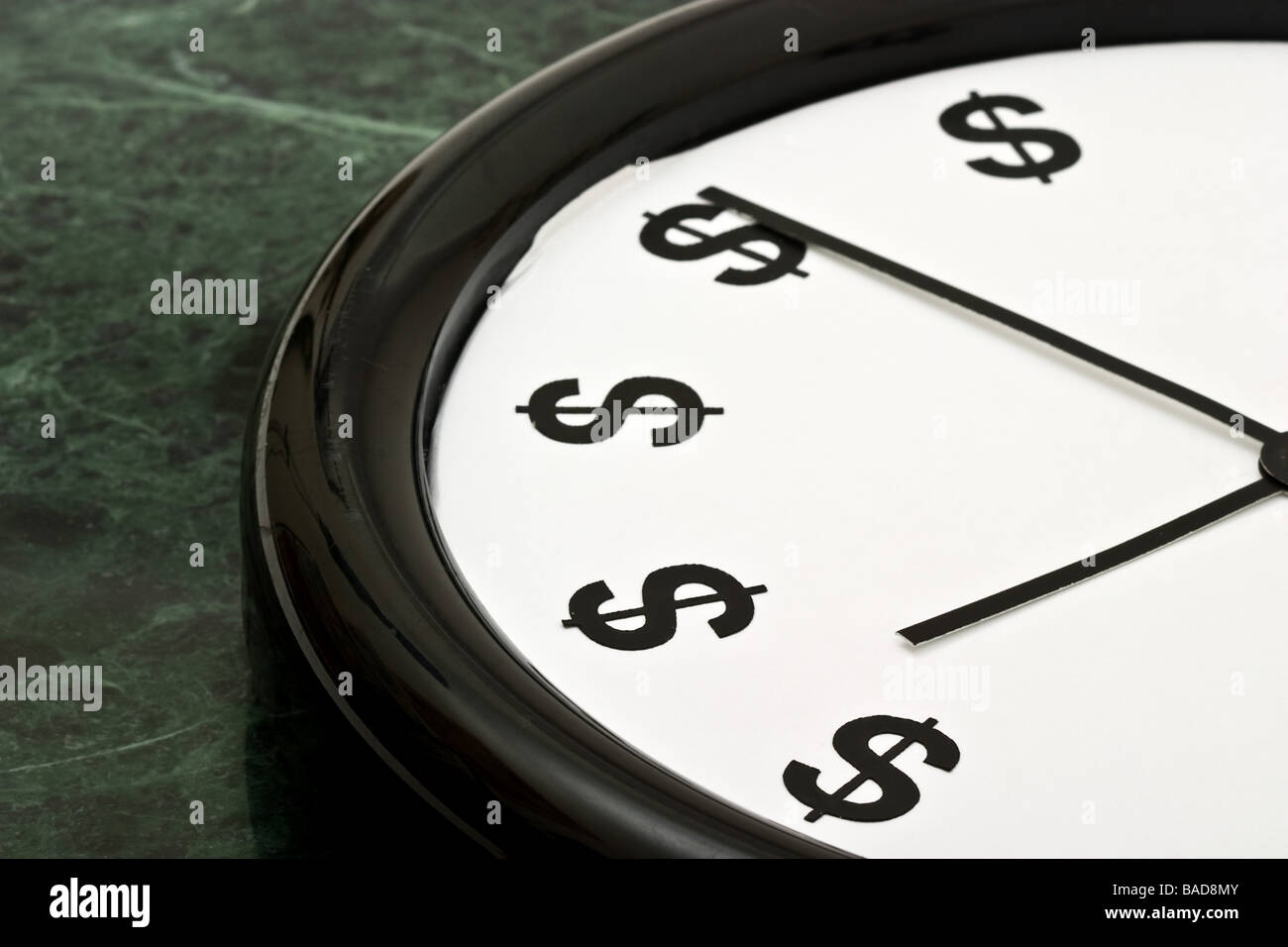 White clock with the hands pointing towards dollar signs Stock Photo