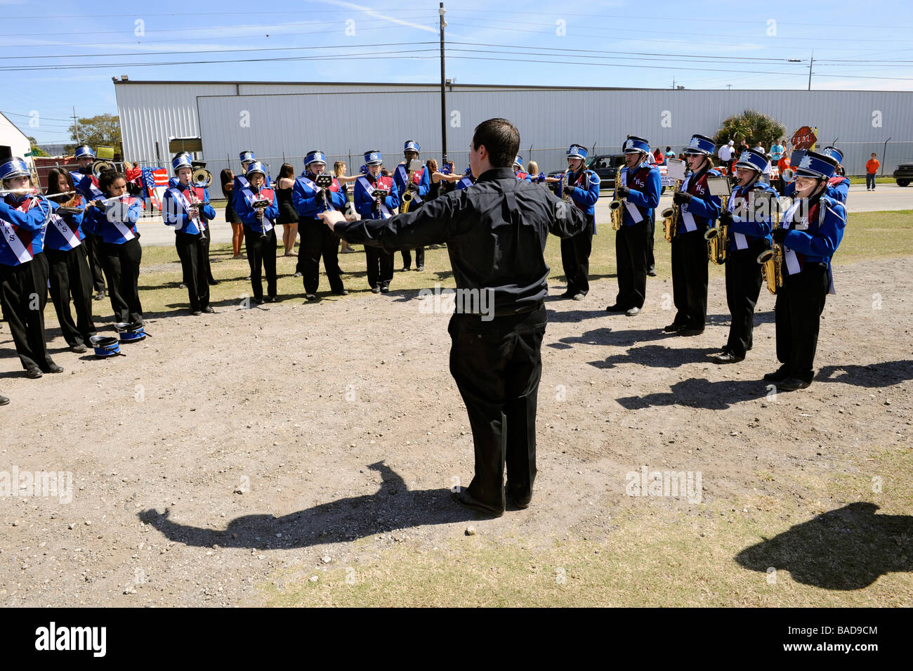 High School Band Members practice with band director at Strawberry Festival Parade Plant City Florida Stock Photo