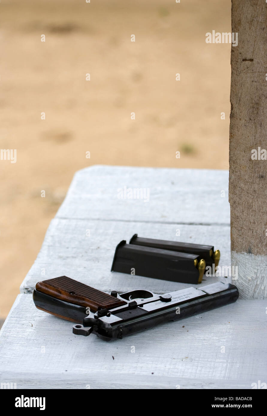 Gun and magazines on table Stock Photo Alamy