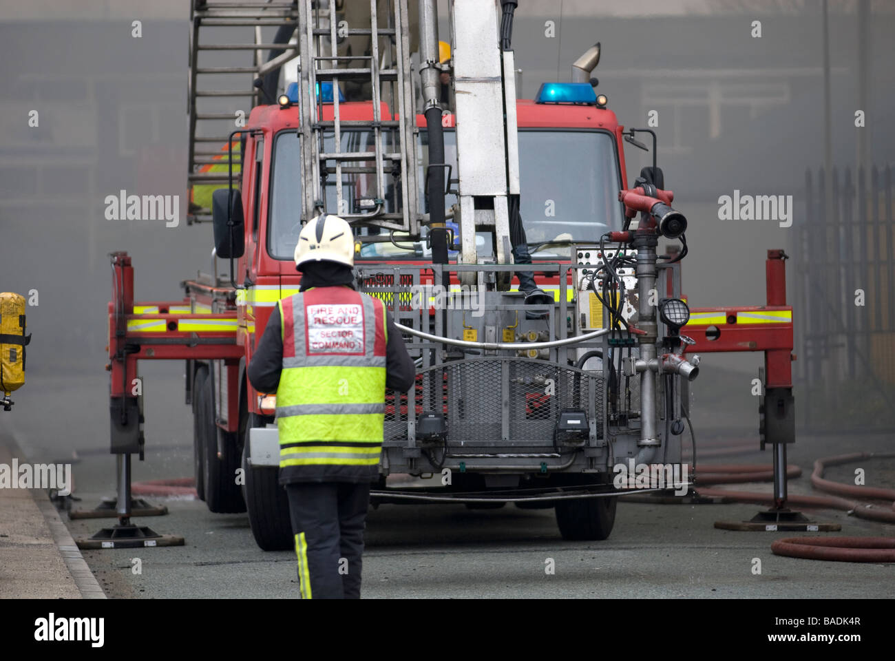 Firefighter in front of fire brigade hydraulic platform FULLY MODEL RELEASED Stock Photo