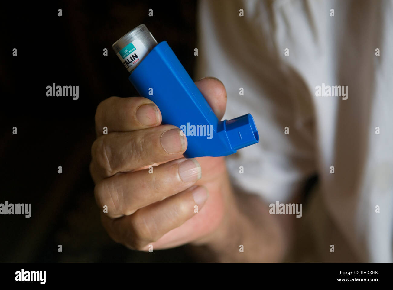 Old man holding an inhaler Stock Photo