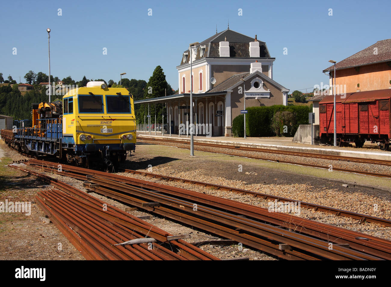 A blue and yellow SNCF track maintenance train in a siding Stock Photo