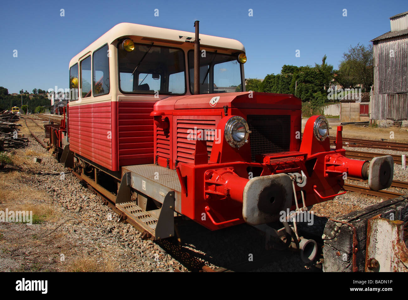 A red and cream SNCF track maintenance train in a siding Stock Photo