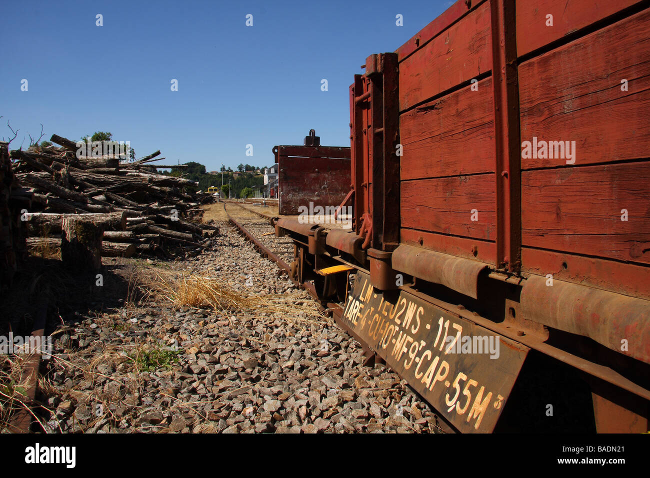 A French goods wagon in a siding at St Leonard de Noblat station Limousin France Clear blue sky beyond Stock Photo