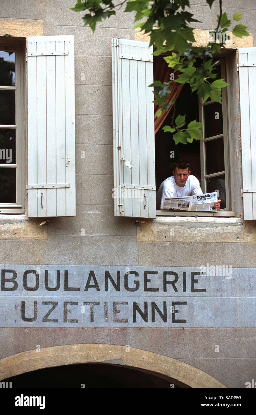 France, Gard, Uzes, 9 Place aux Herbes, a man reading a newspaper at