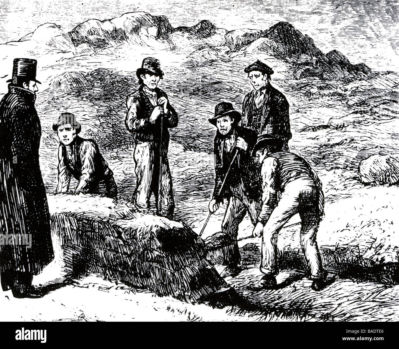 IRISH PEAT DIGGERS watched by the landowner Stock Photo