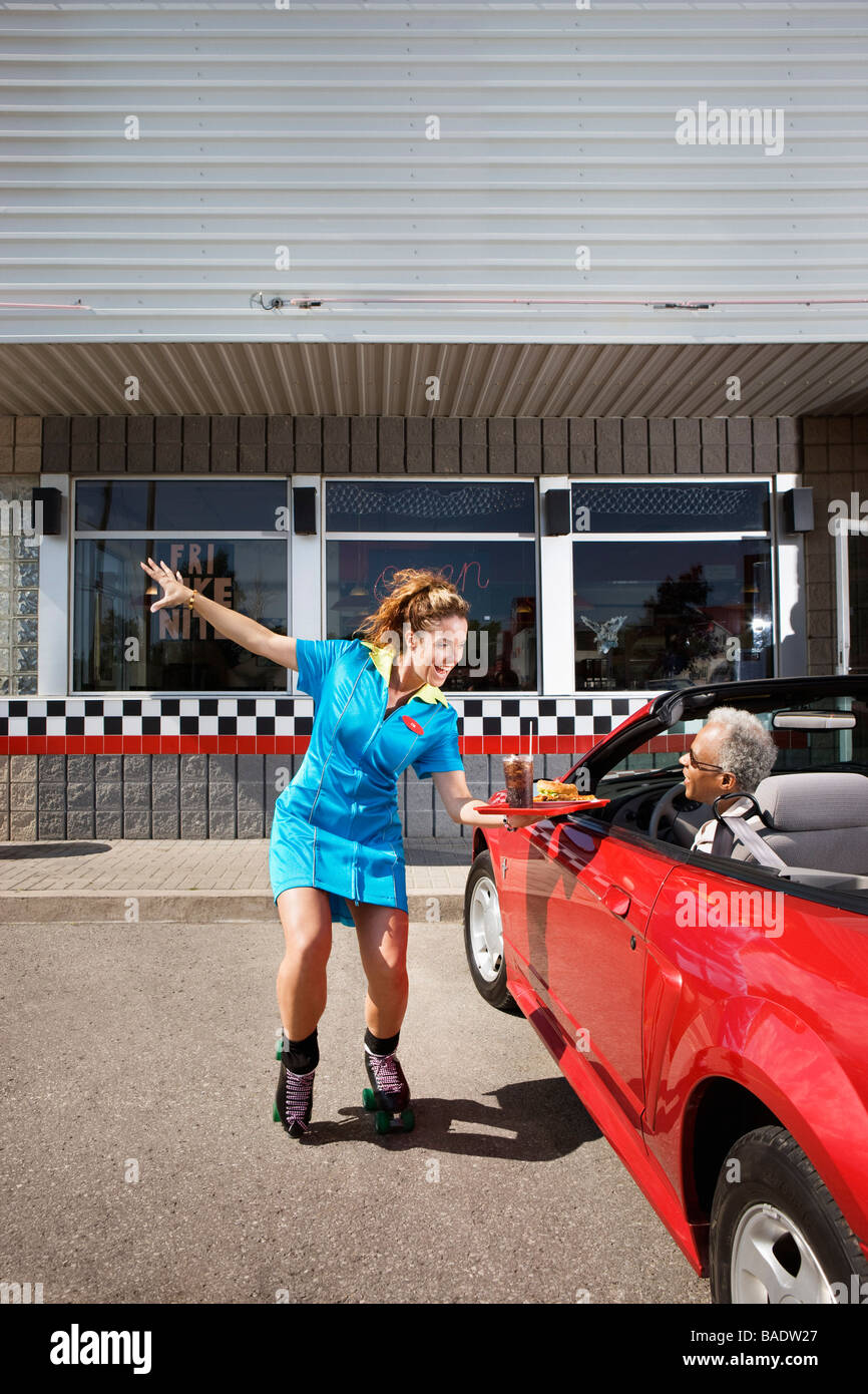Woman Serving Man in Convertible at 1950s Diner, Niagara Falls, Ontario, Canada Stock Photo