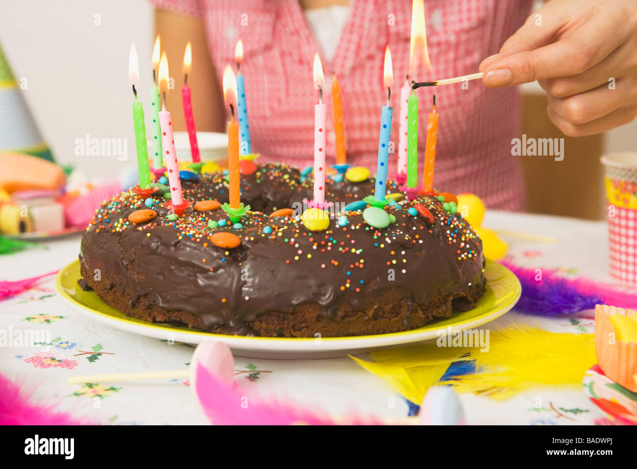 Woman Lighting Candles on Birthday Cake Stock Photo Alamy
