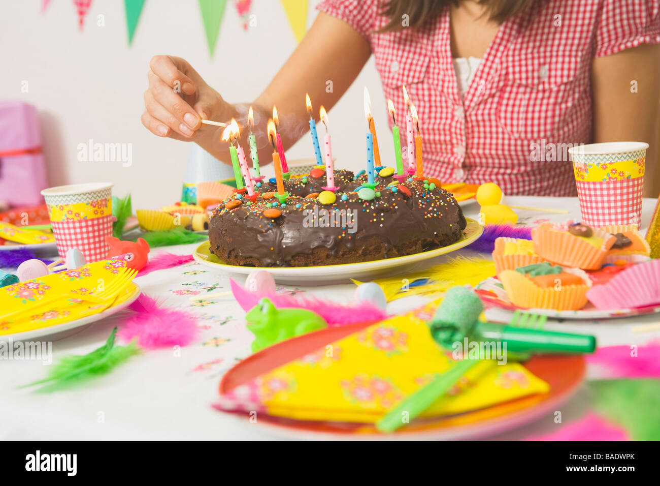 Woman Lighting Candles on Birthday Cake Stock Photo Alamy