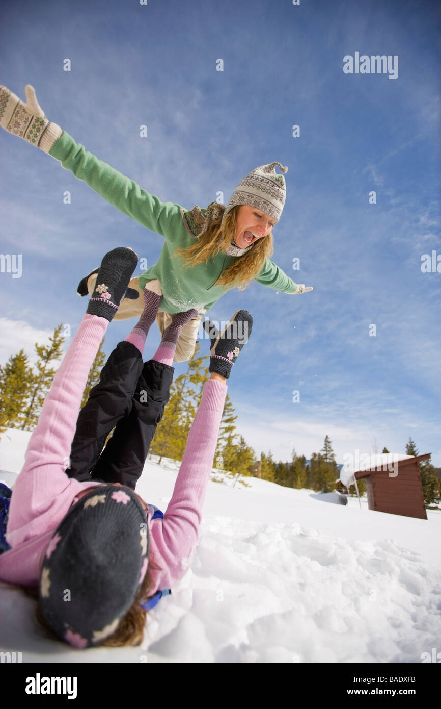 Two Women Playing in the Snow, Near Frisco, Summit County, Colorado, USA Stock Photo