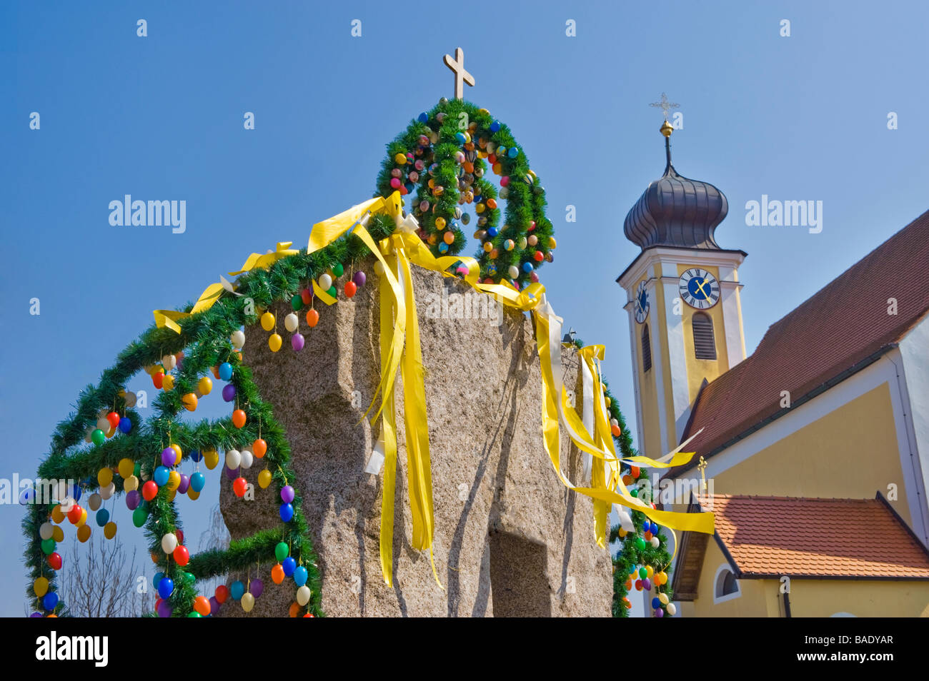easter fountain church tradition traditional eggs colored cross tower happy lanyard germany bavaria typical typically bayern sy Stock Photo