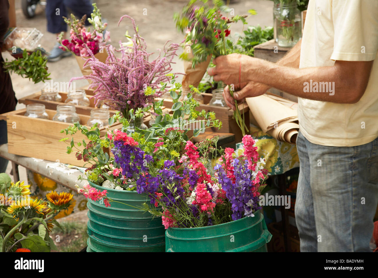 Flower Vendor Selling Flowers at Organic Farmer's market Stock Photo