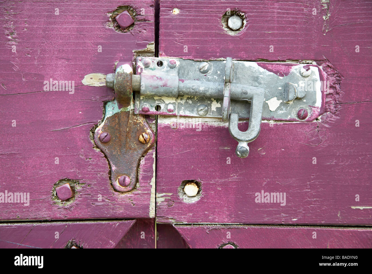 Close-Up of Sliding Bolt Lock on Purple Gate Stock Photo