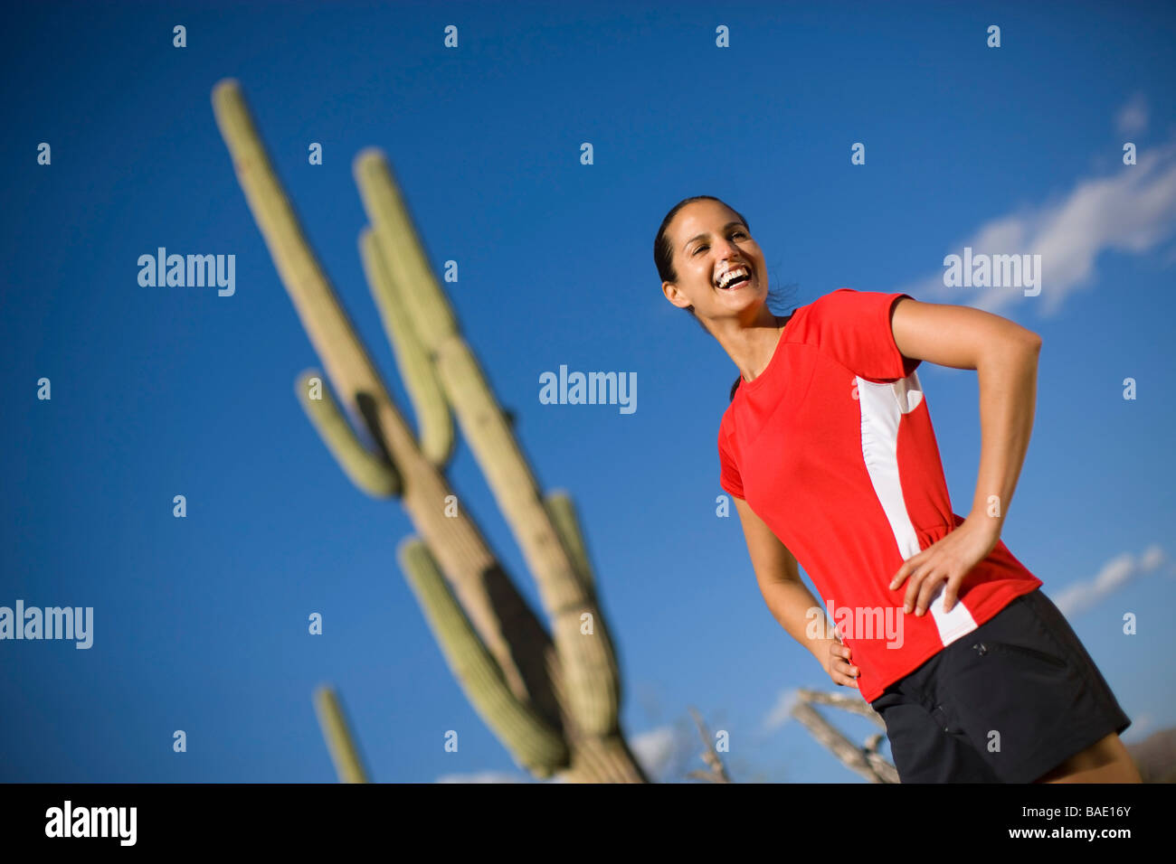 Woman Standing in Front of a Saguaro Cactus, Tucson, Arizona, USA Stock Photo