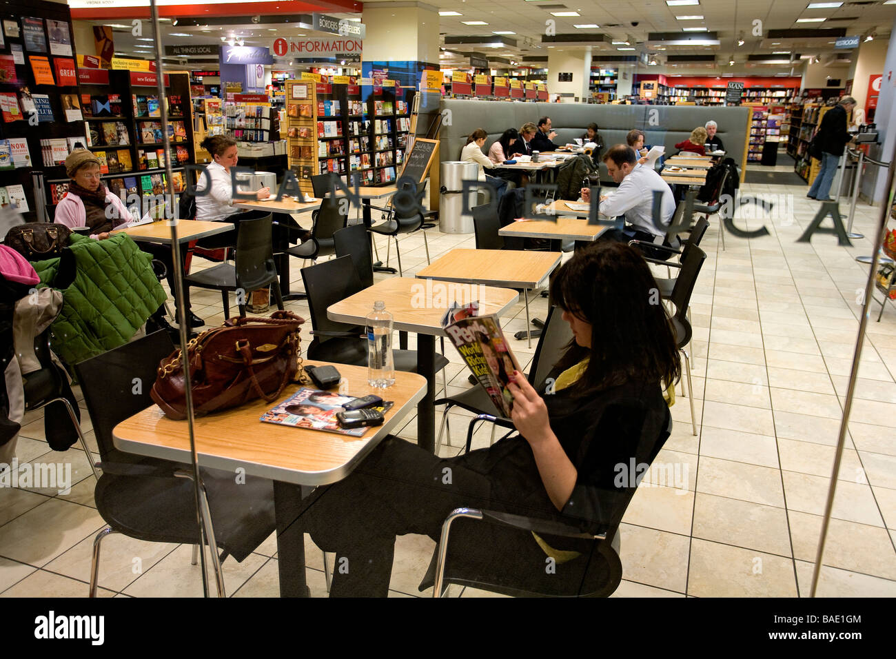 United States, New York, Time Warner Center, Dean and Deluca Cafe in Borders Books and Music Store, Young Lady reading a Stock Photo