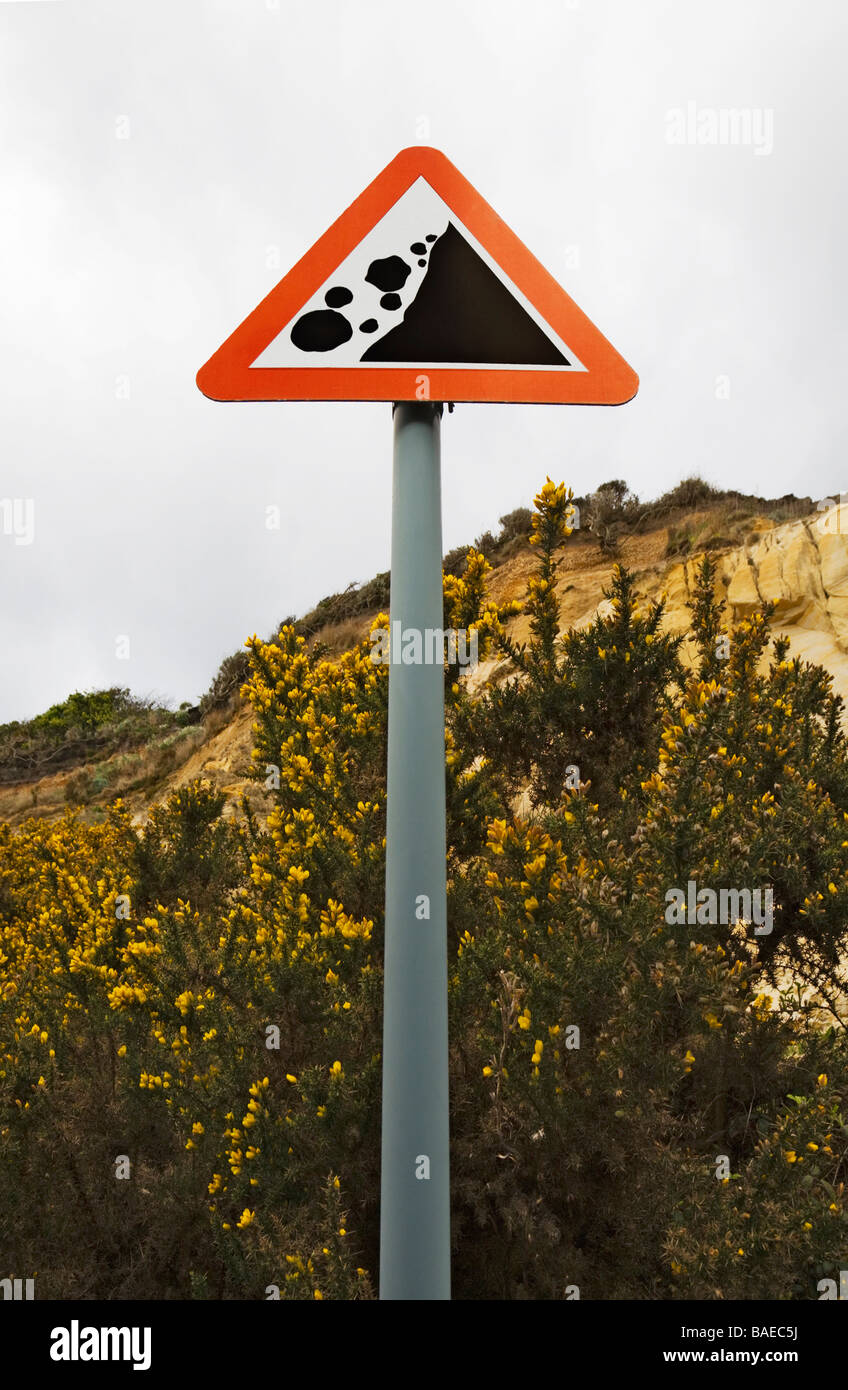 A sign on Bournemouth beach, at the base of the cliff, warning of the danger of rock fall due to coastal erosion. Dorset. UK Stock Photo