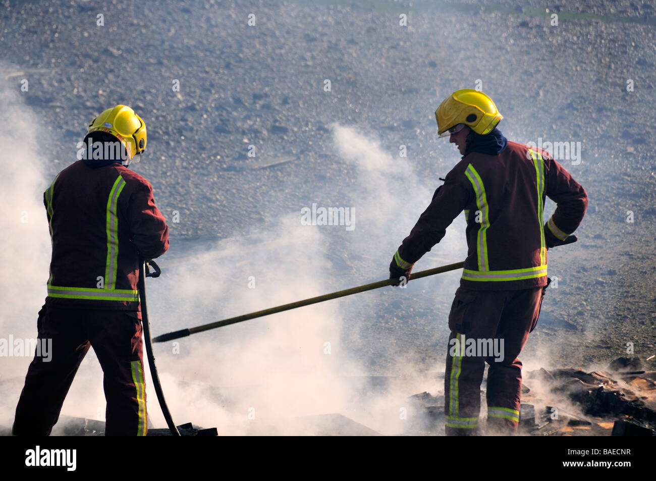 firemen extinguishing a fire on the river bed, river thames Stock Photo
