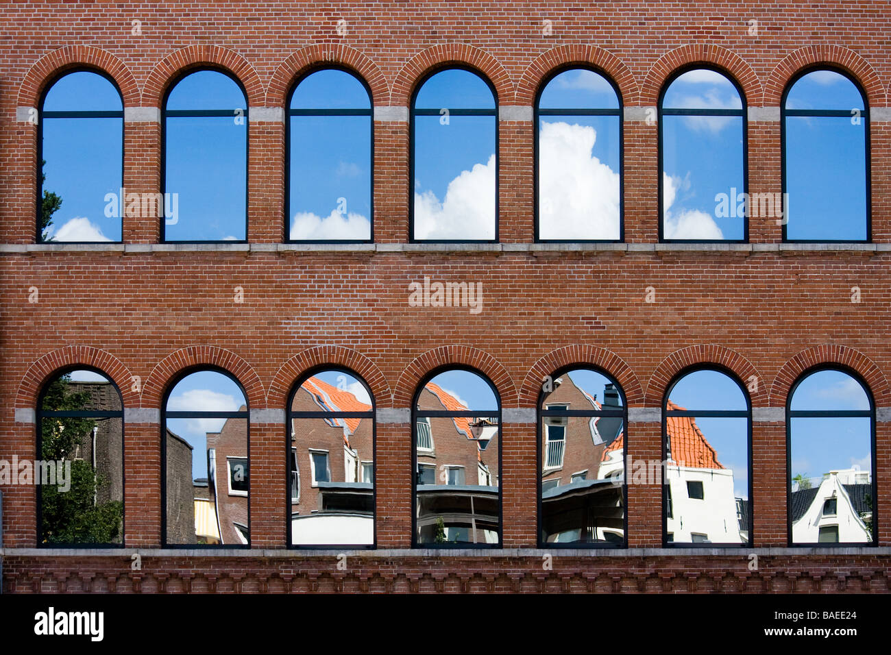 Typical Netherlands houses are reflected in a relatively modern building Shot in Amsterdam Netherlands Stock Photo