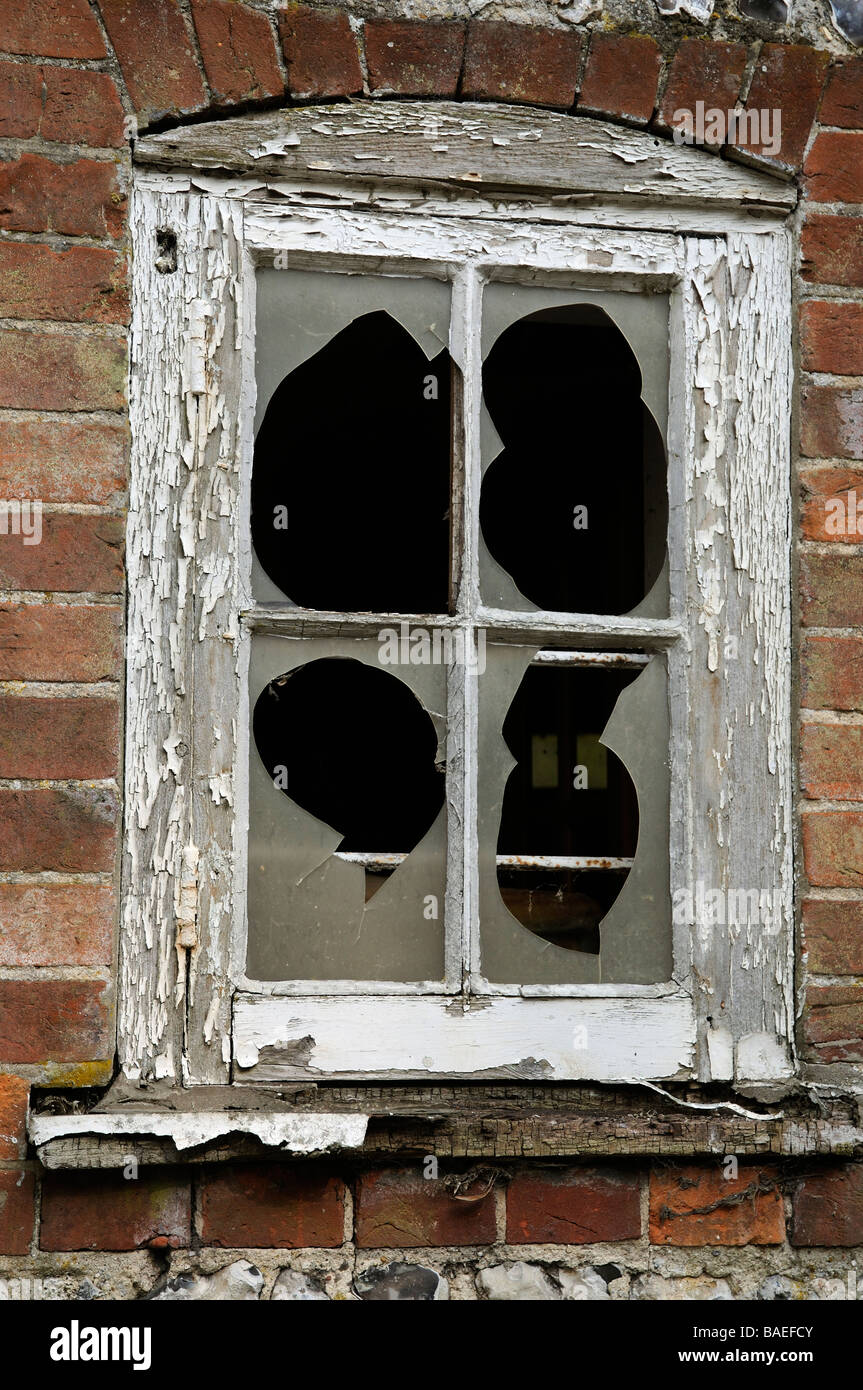 Broken windows and window frame with peeling paintwork Stock Photo Alamy