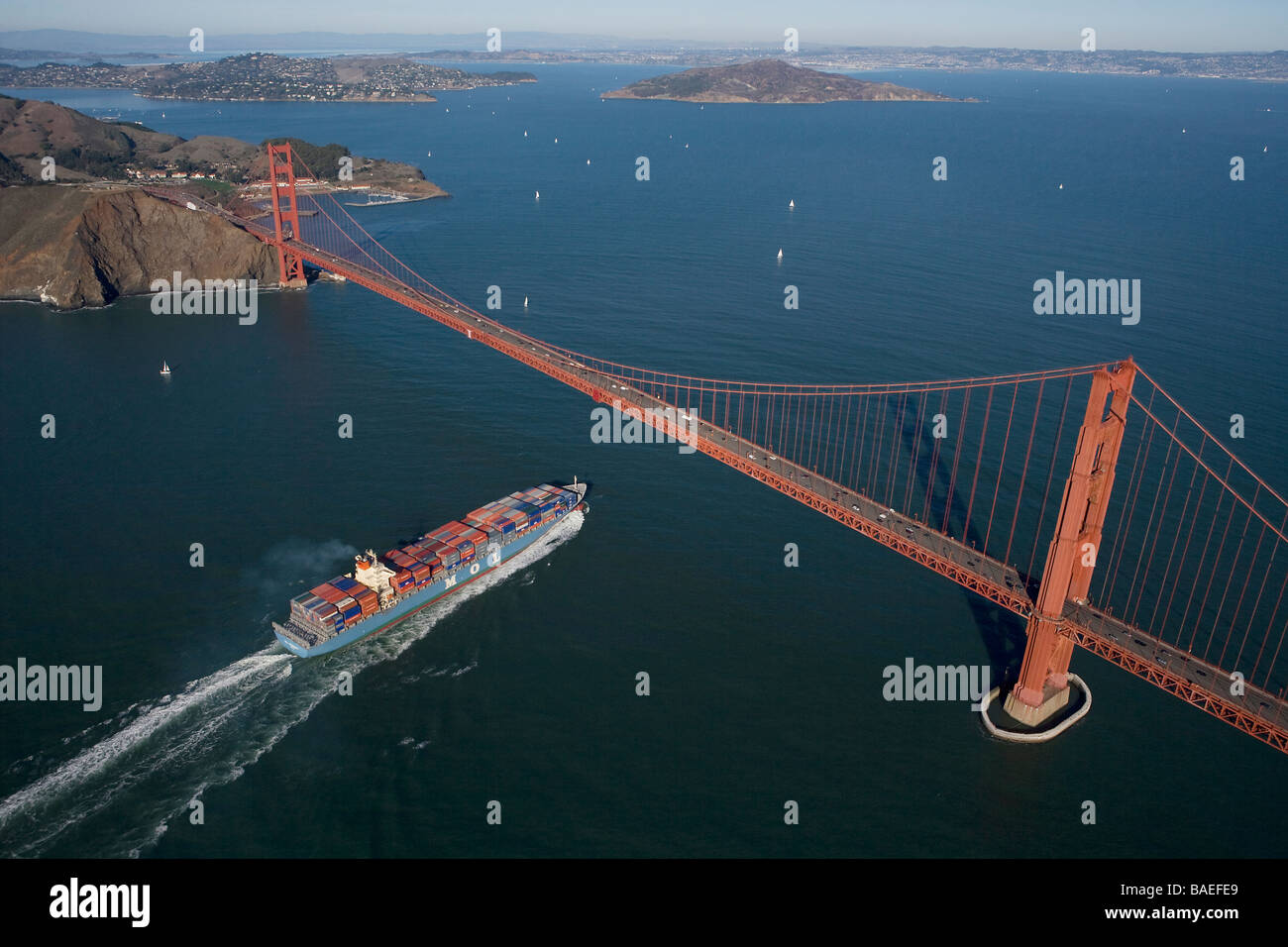 aerial view above loaded MOL container ship passing under the Golden Gate bridge into San Francisco Bay Stock Photo