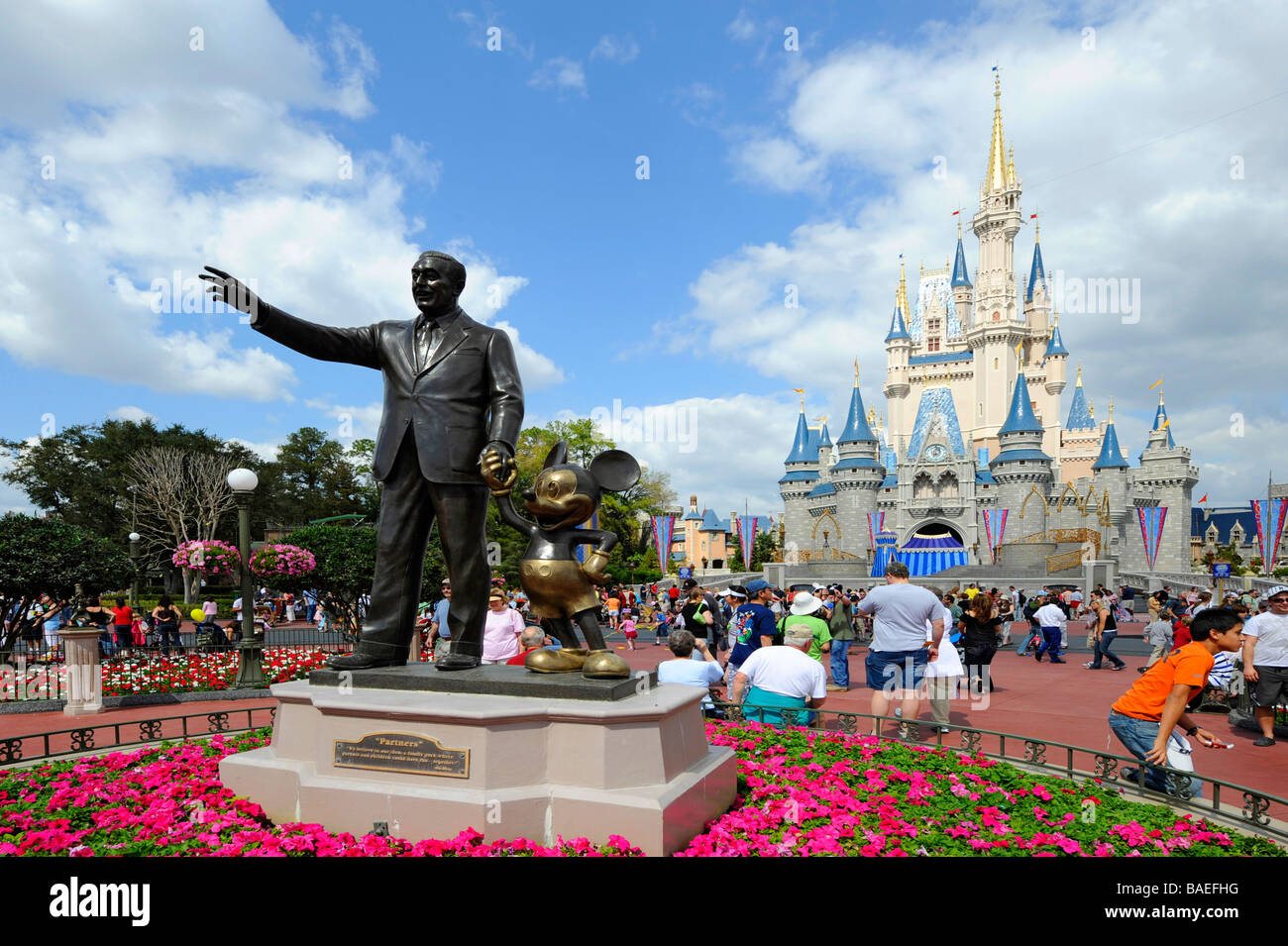 Statue of Walt Disney and Mickey Mouse in front of Cinderella Castle at Magic Kingdom Theme Park Orlando Florida Central Stock Photo