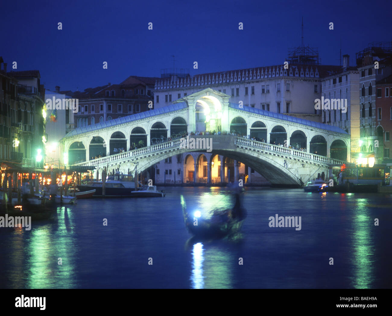 Gondola on Grand Canal with Rialto Bridge in background Venice Veneto Italy Stock Photo