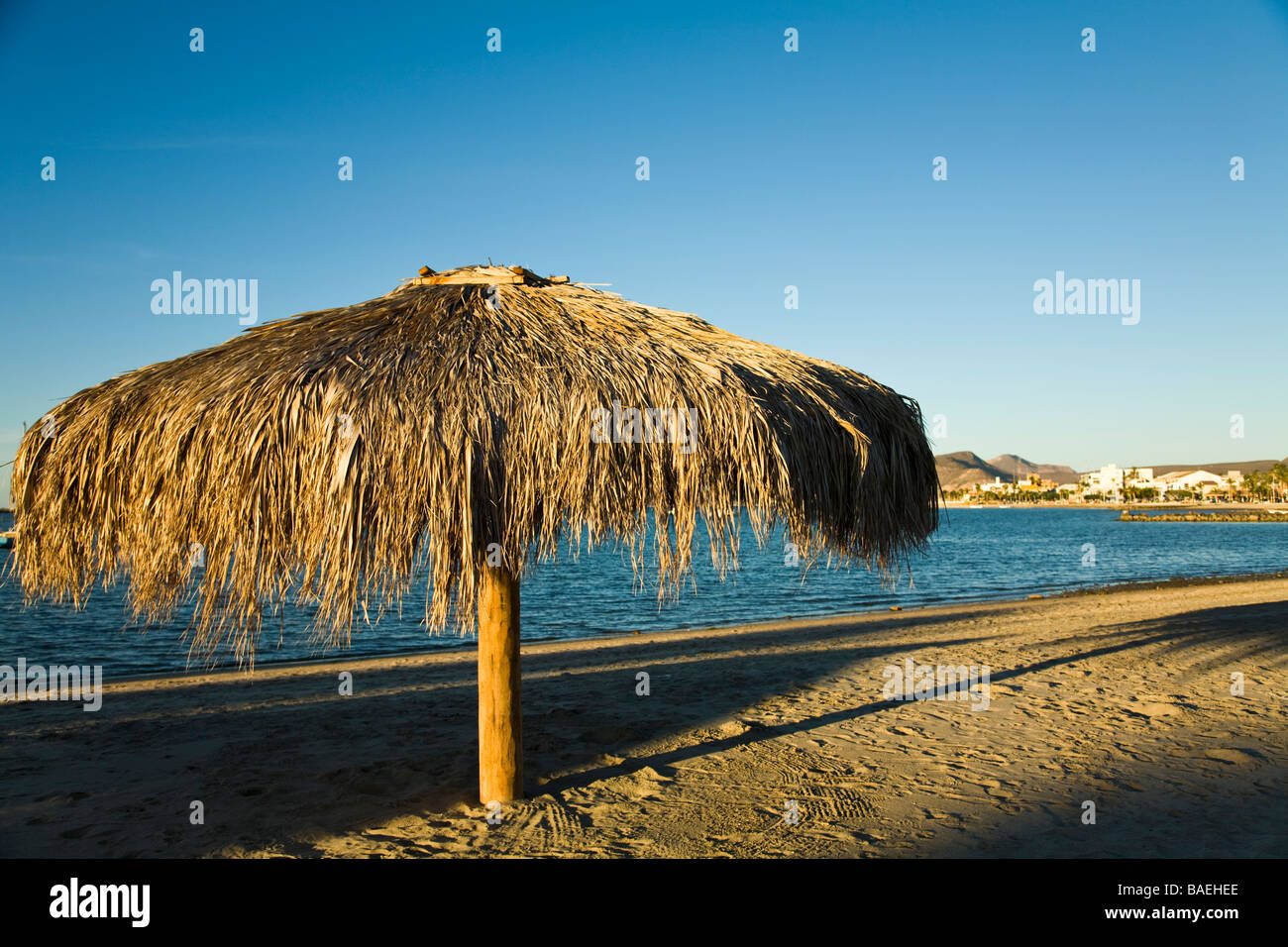 MEXICO La Paz Palapa thatched umbrellas on beach along bay Stock Photo