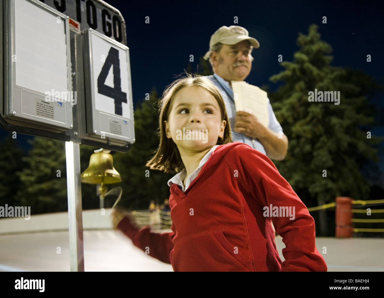 ILLINOIS Northbrook Young girl ring bell during bicycle race at velodrome track referee stand by Stock Photo