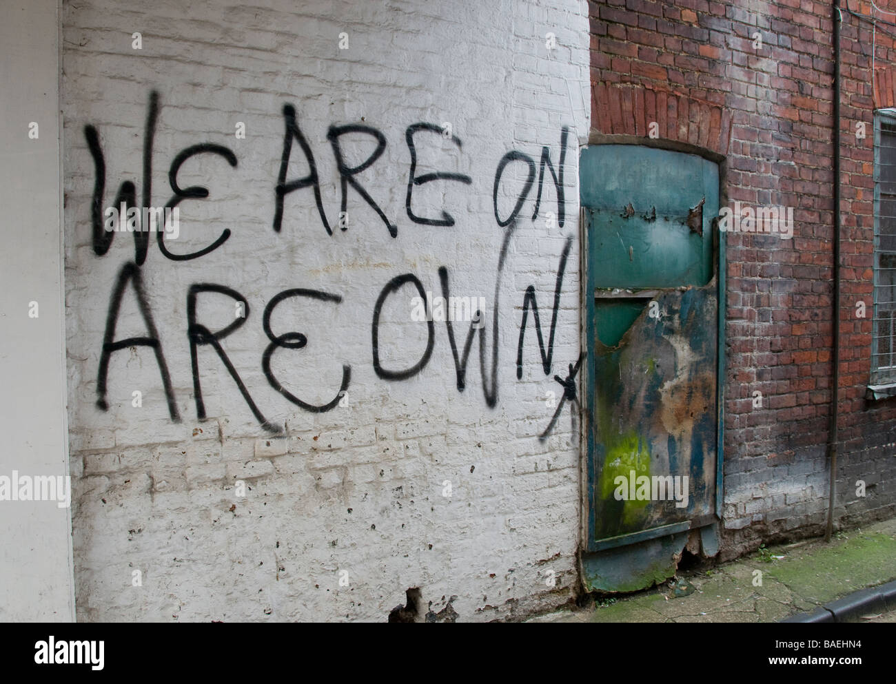 Graffiti on white brick wall in a run down area, stating 'we are on Stock  Photo - Alamy