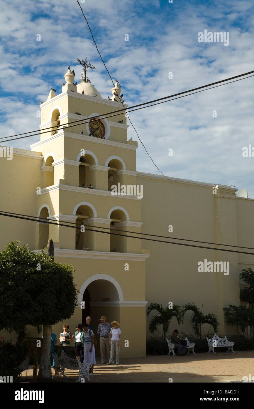 MEXICO Todos Santos Bell tower and entrance to Mission of Santa Rosa de Todos Santos church tourists walking outside building Stock Photo