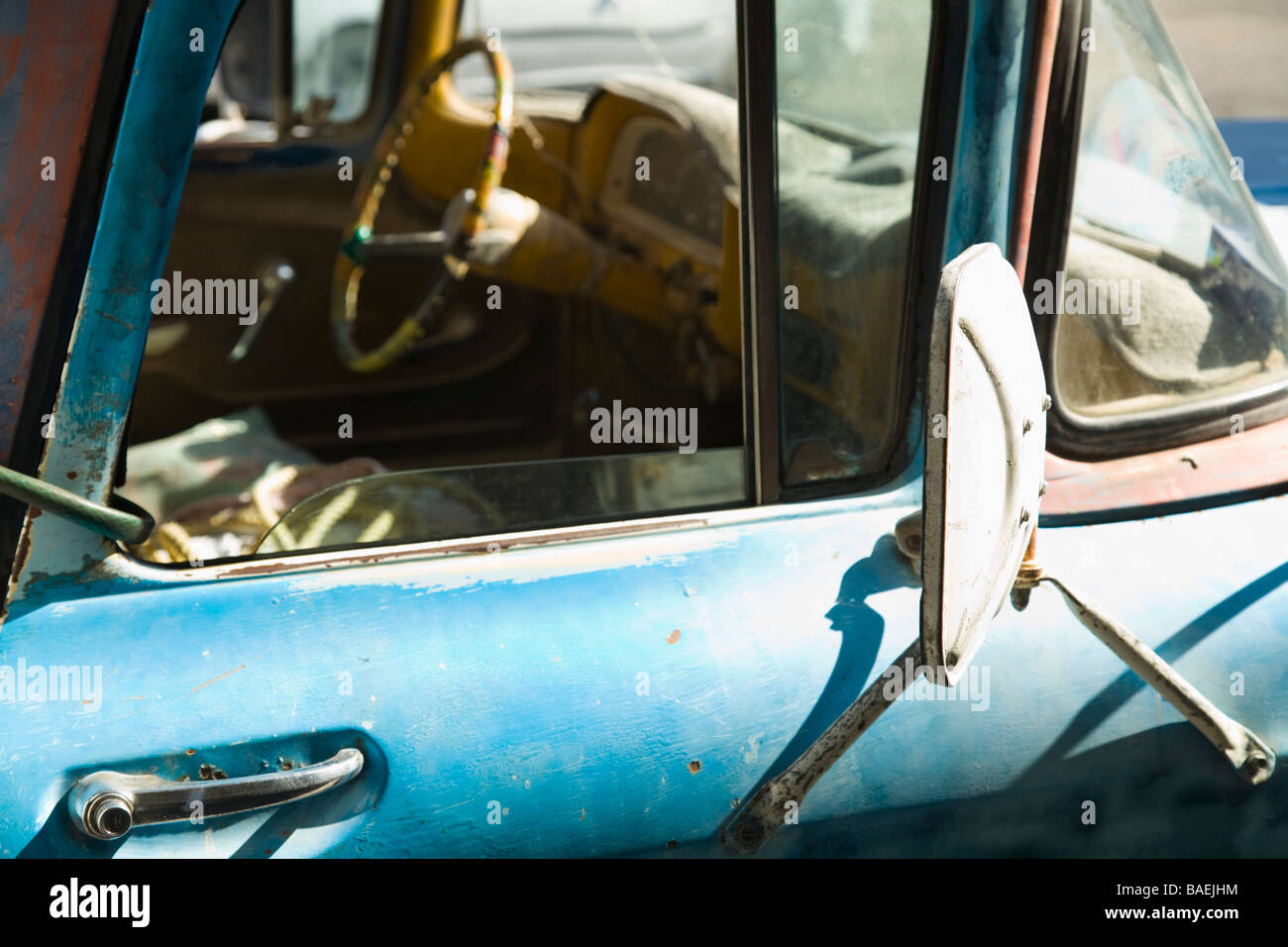 MEXICO La Paz Old blue weathered pick up truck parked view through passenger window steering wheel and dashboard Stock Photo