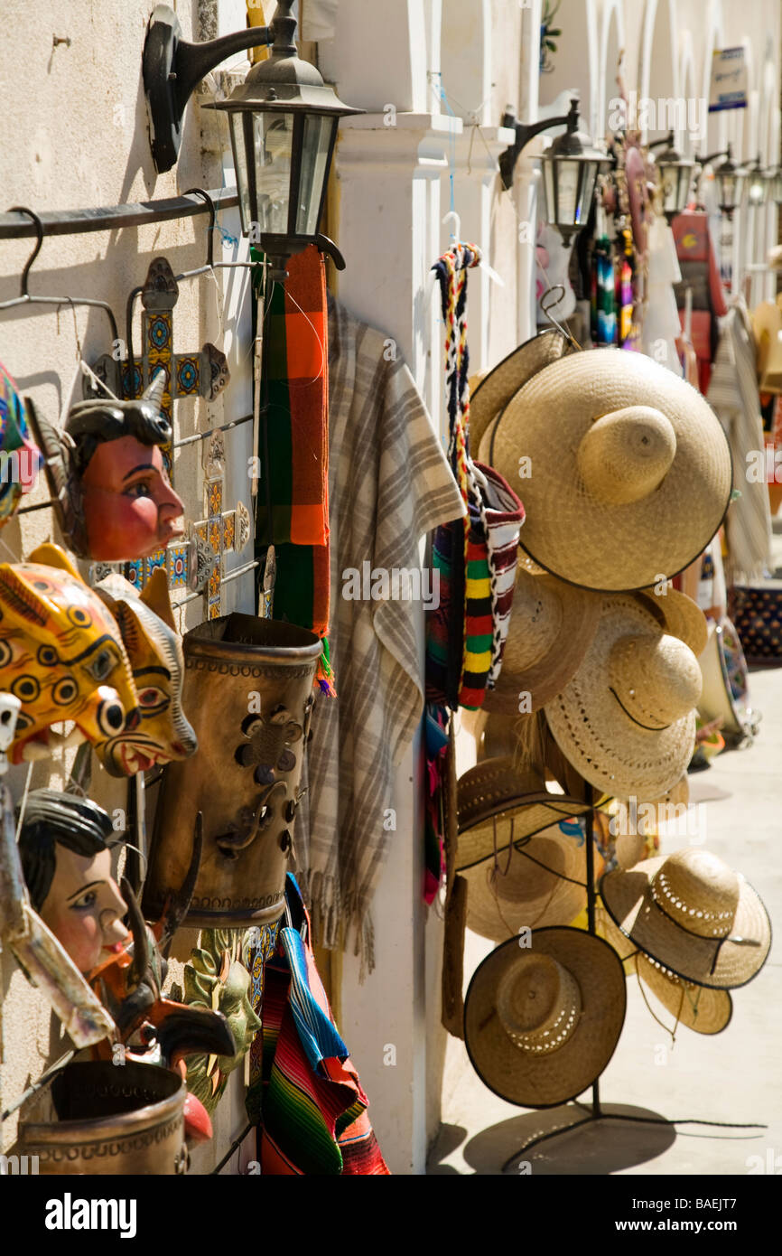 MEXICO Todos Santos Painted masks and straw hats hanging on display