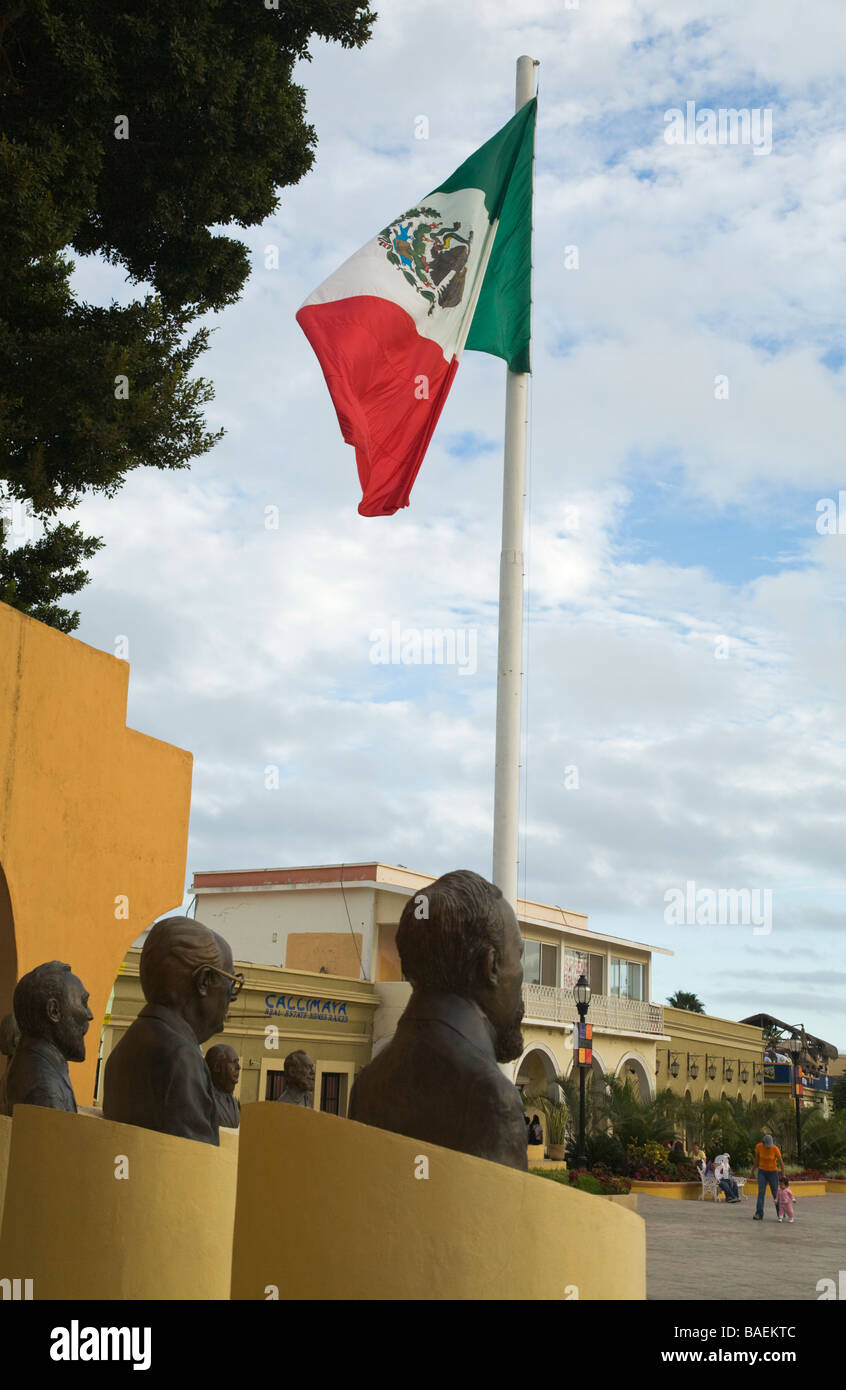 MEXICO San Jose del Cabo Busts on display around downtown plaza Mexican flag flying stores and restaurants in business district Stock Photo