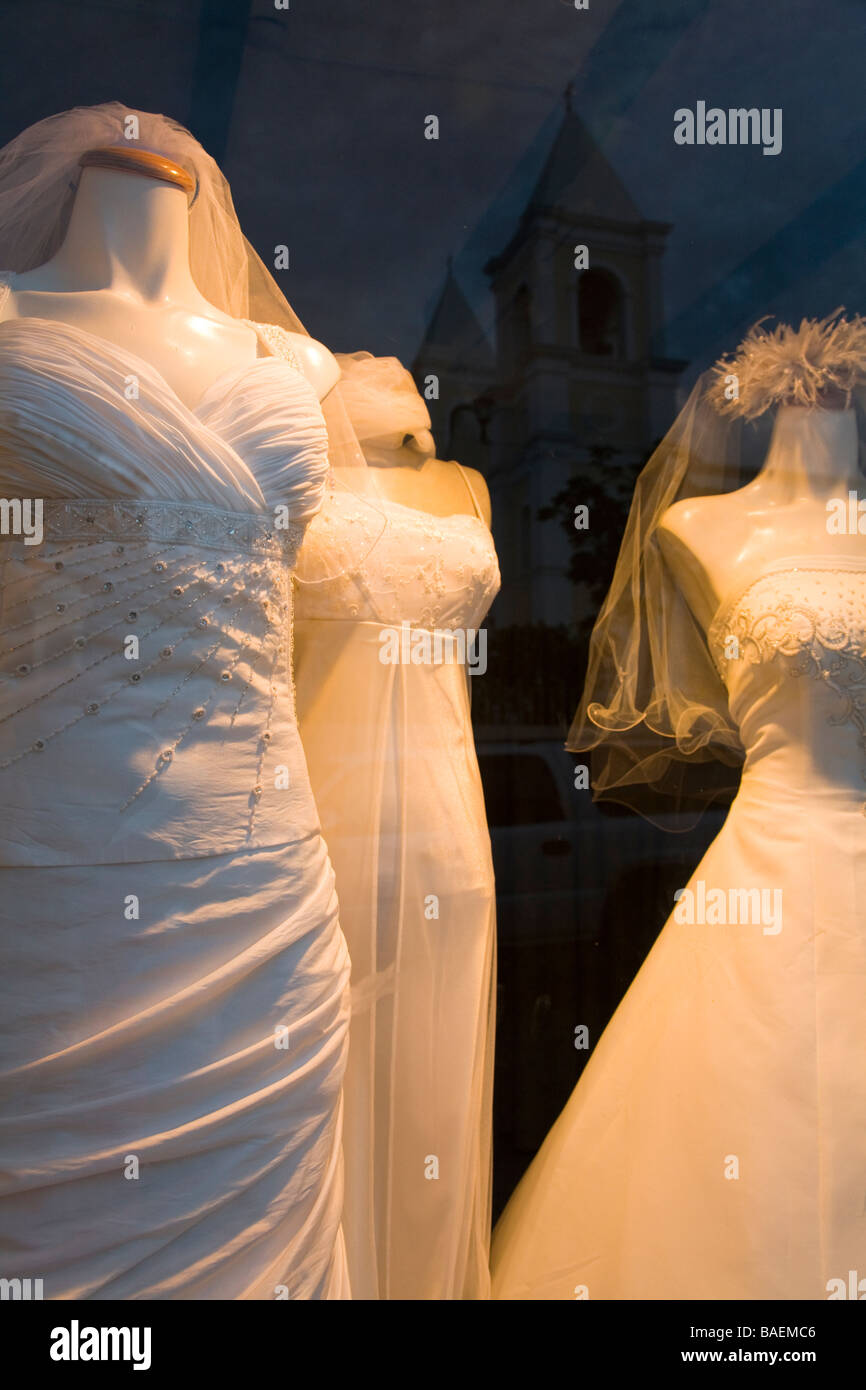 MEXICO San Jose del Cabo Reflection of twin towers of Iglesia San Jose church seen in window of store with wedding dresses Stock Photo