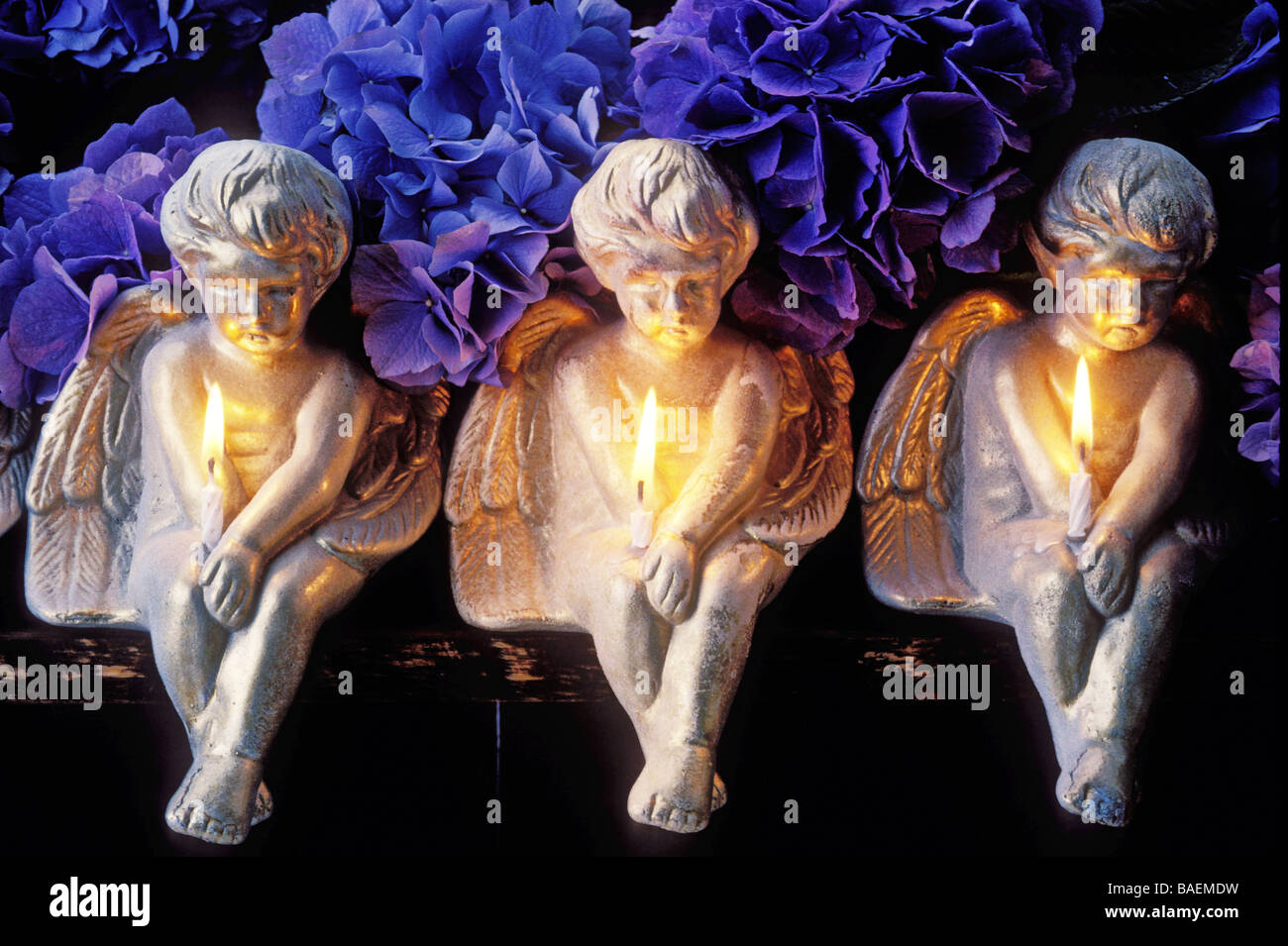 Three angels holding candles Stock Photo Alamy
